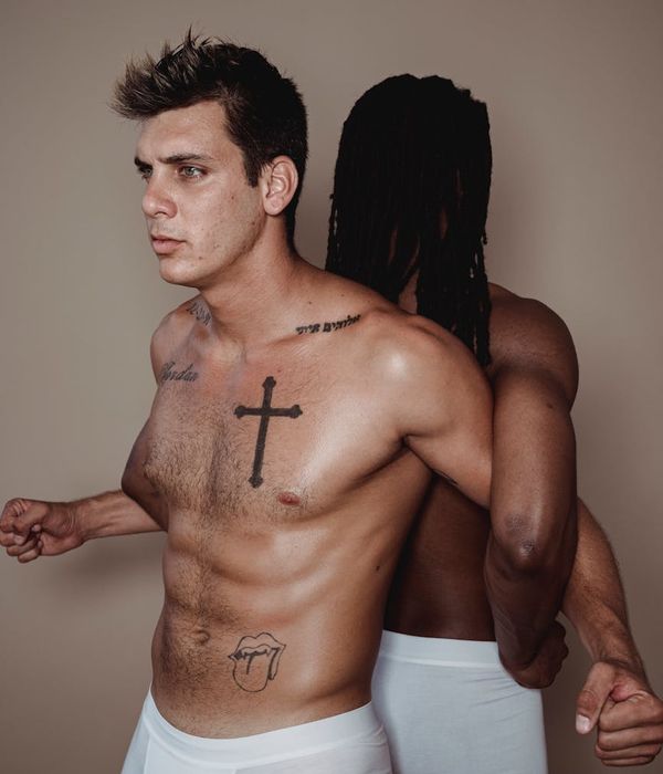 Man performing a controlled strength exercise in a bright, clean studio.